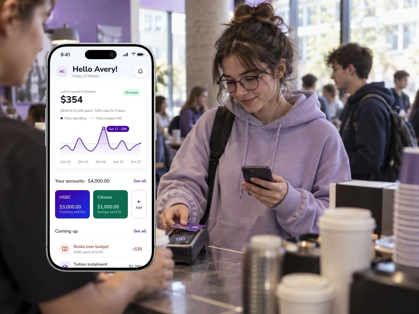 A student in a lilac hoodie pays with her card in a busy campus café, next to the BlueBubble app showing $354 left to spend this month, her accounts and what's coming up