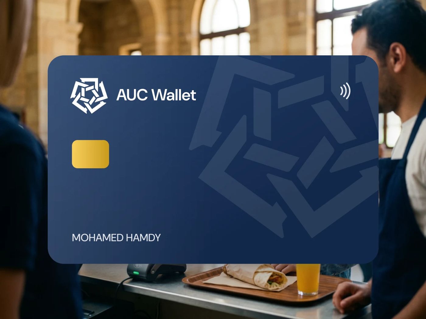 A student pays for lunch at the AUC food court with her phone, with the navy AUC Wallet card in front showing the AUC mark and the name Mohamed Hamdy