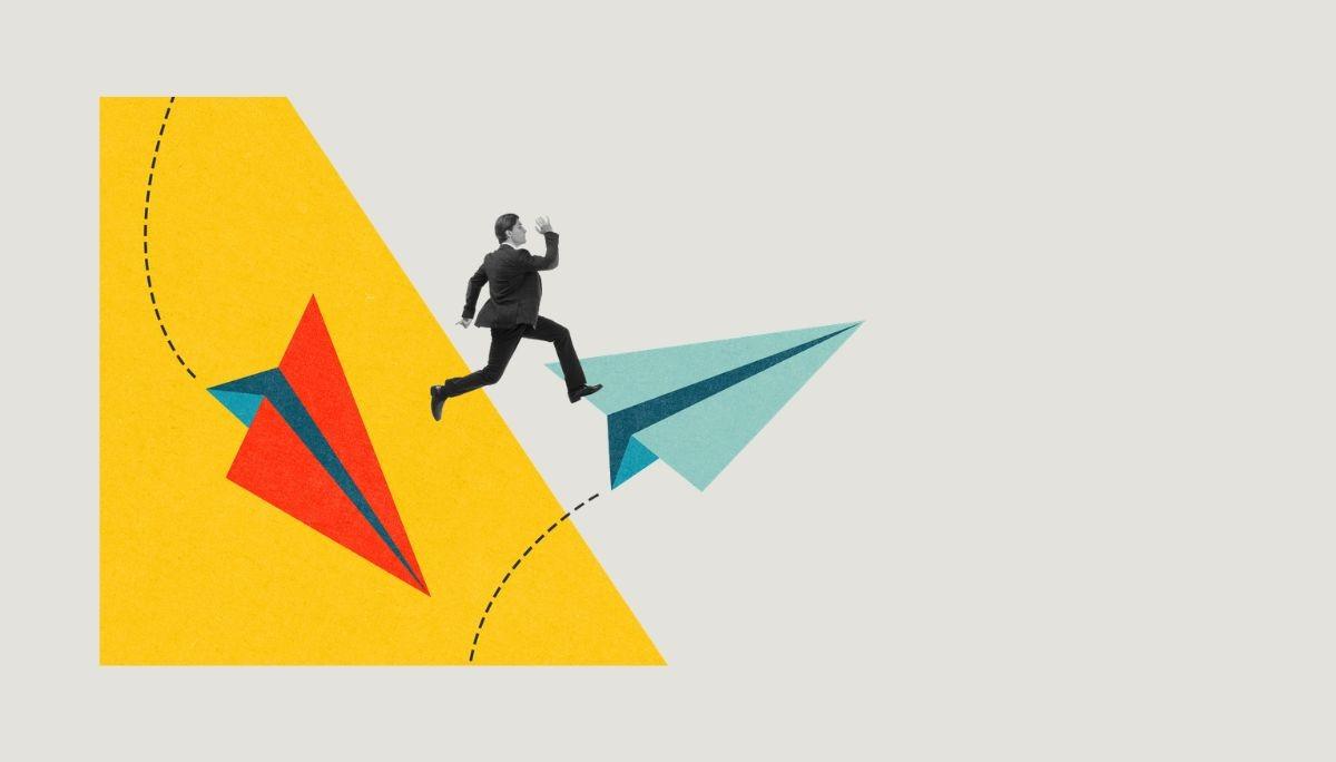 Businessperson jumping between paper airplanes, representing progress toward a third-round interview.