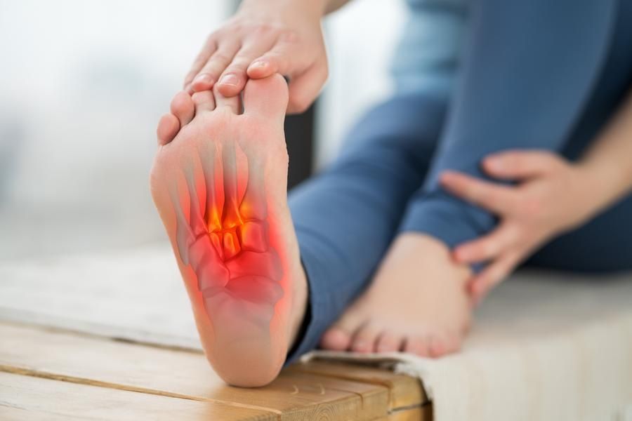 Woman's foot in pain from plantar fasciitis