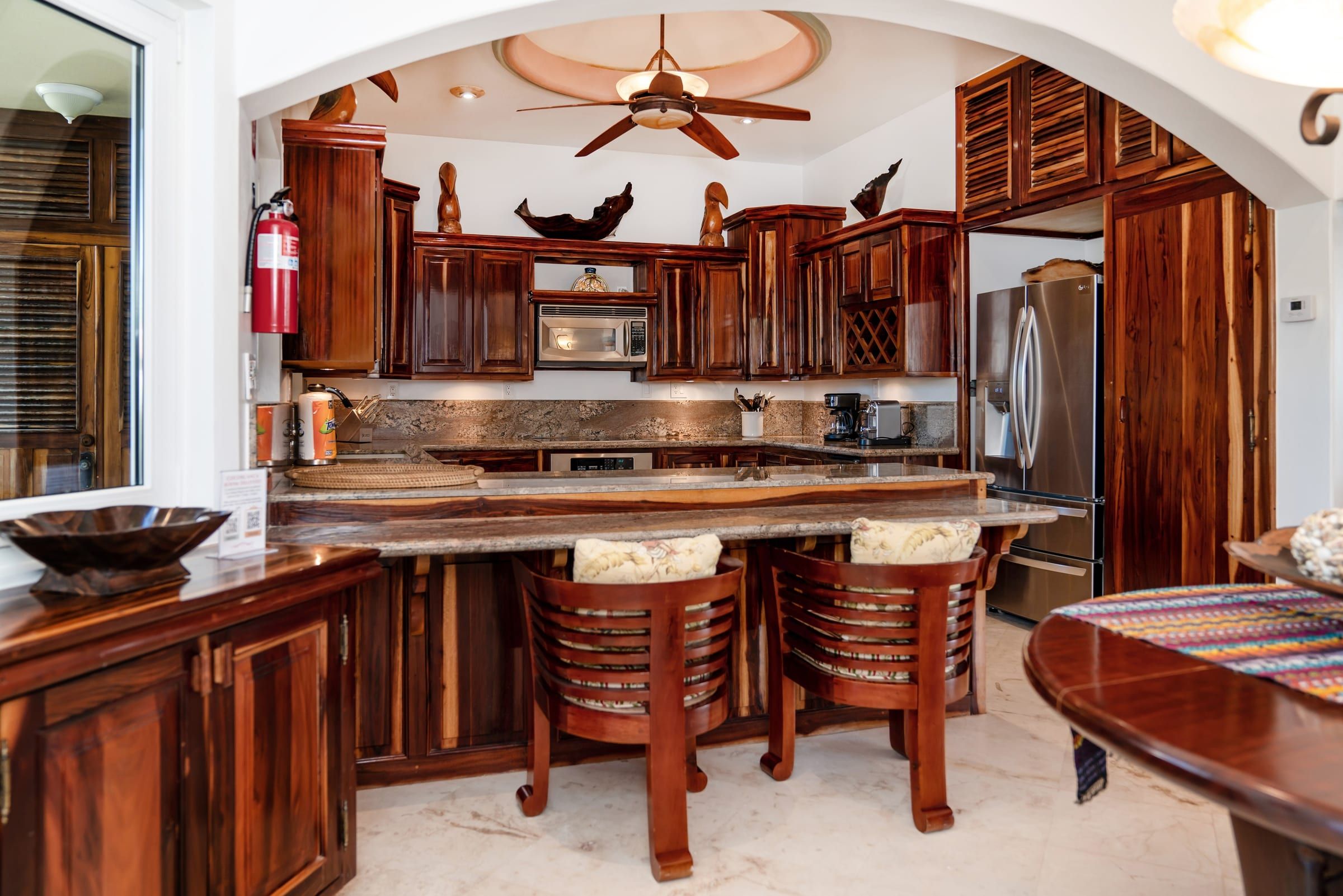 Kitchen with hardwood cabinets, granite counters and a breakfast bar