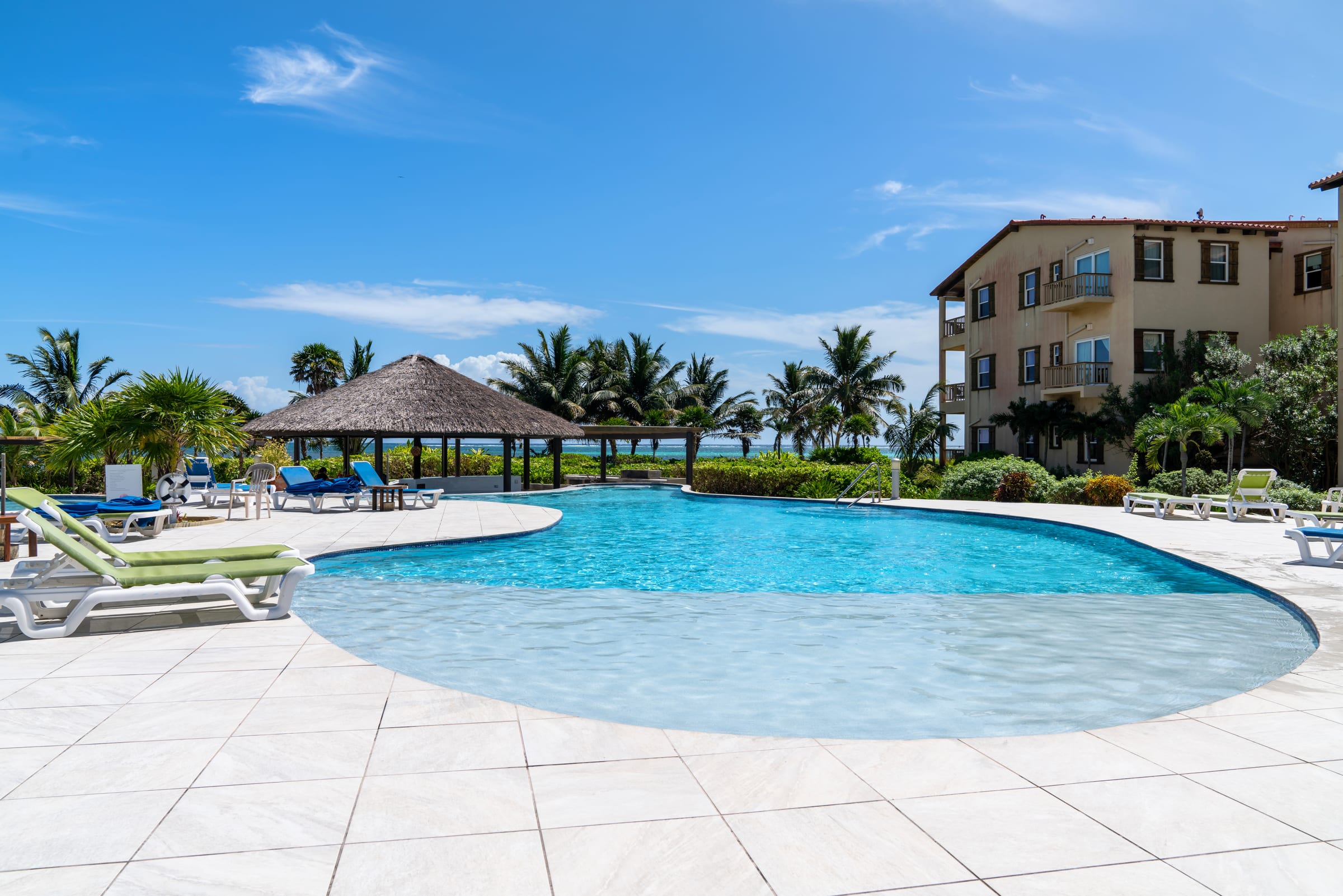 Shallow beach-entry pool with lounge chairs