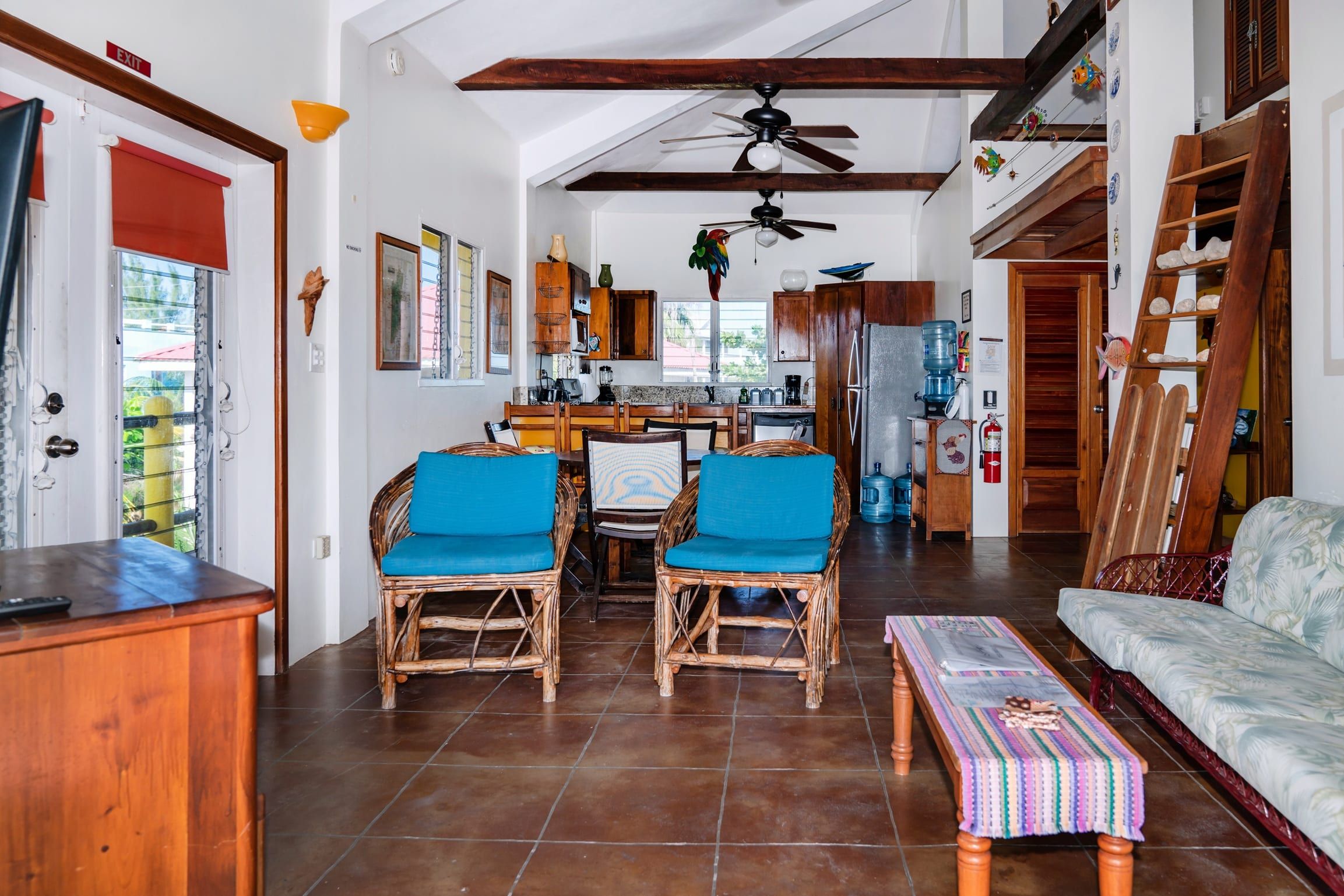 Open living and dining area with blue-cushioned seating