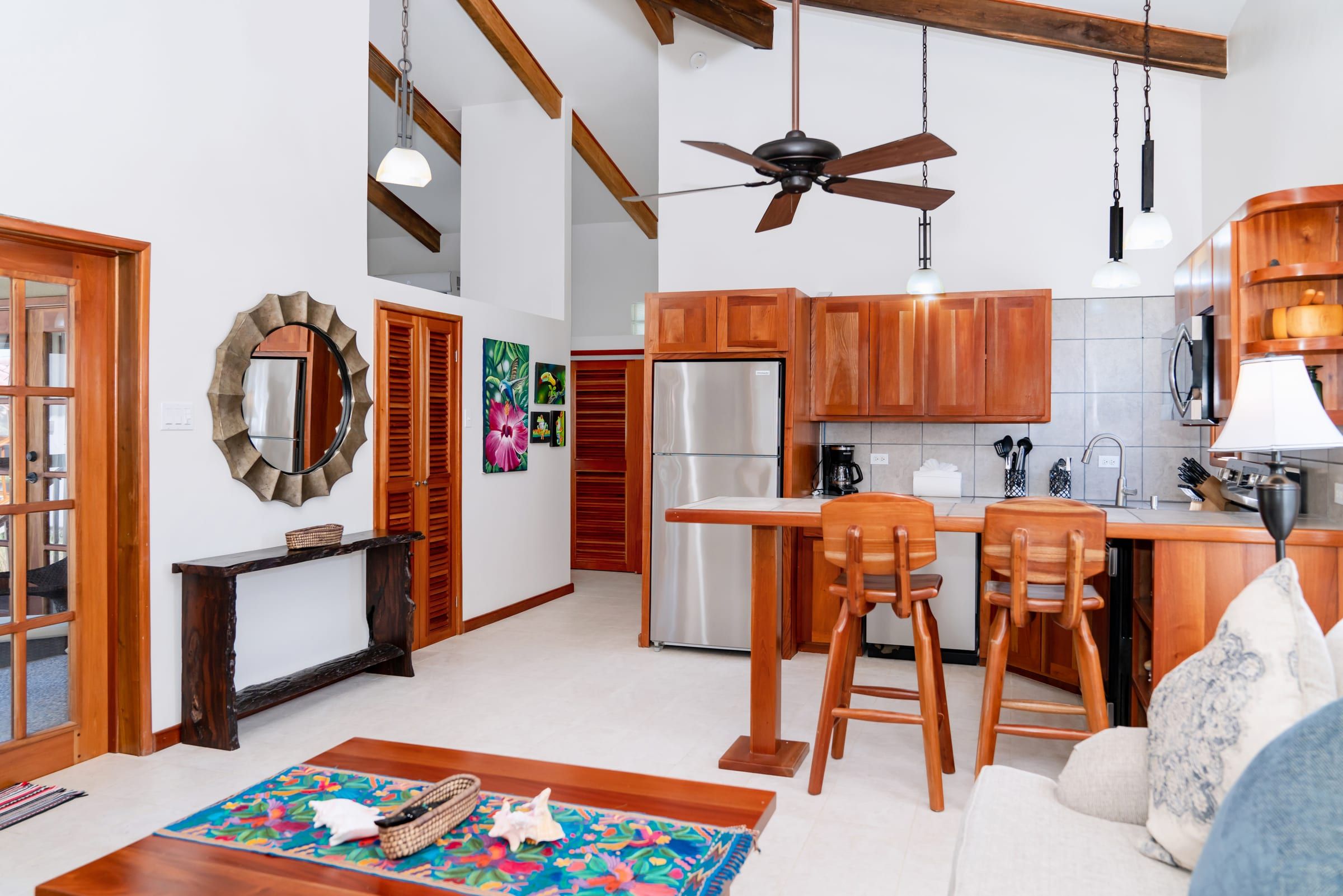 Open living area and kitchen under a beamed ceiling