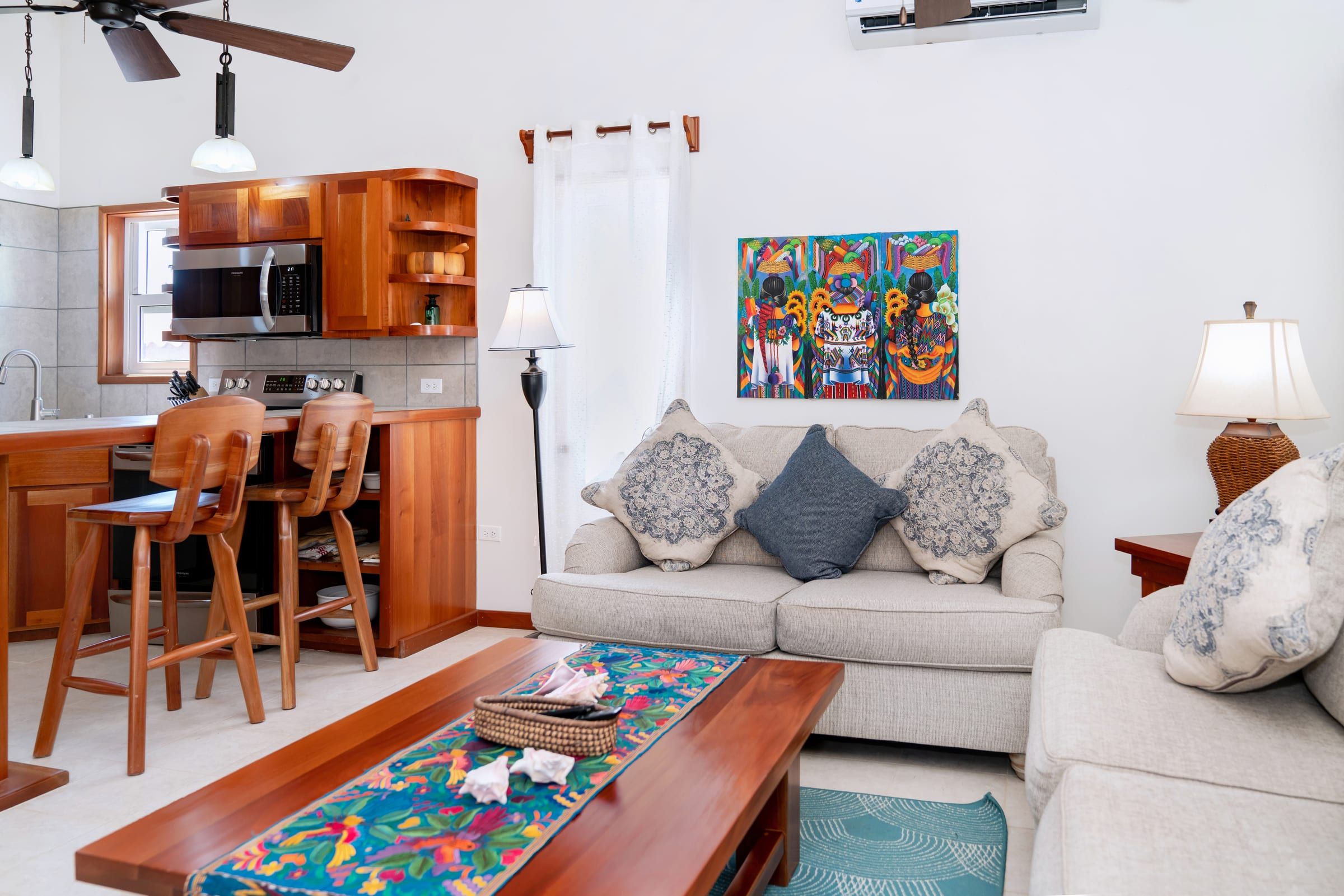 Living room with a sofa and an open kitchen behind