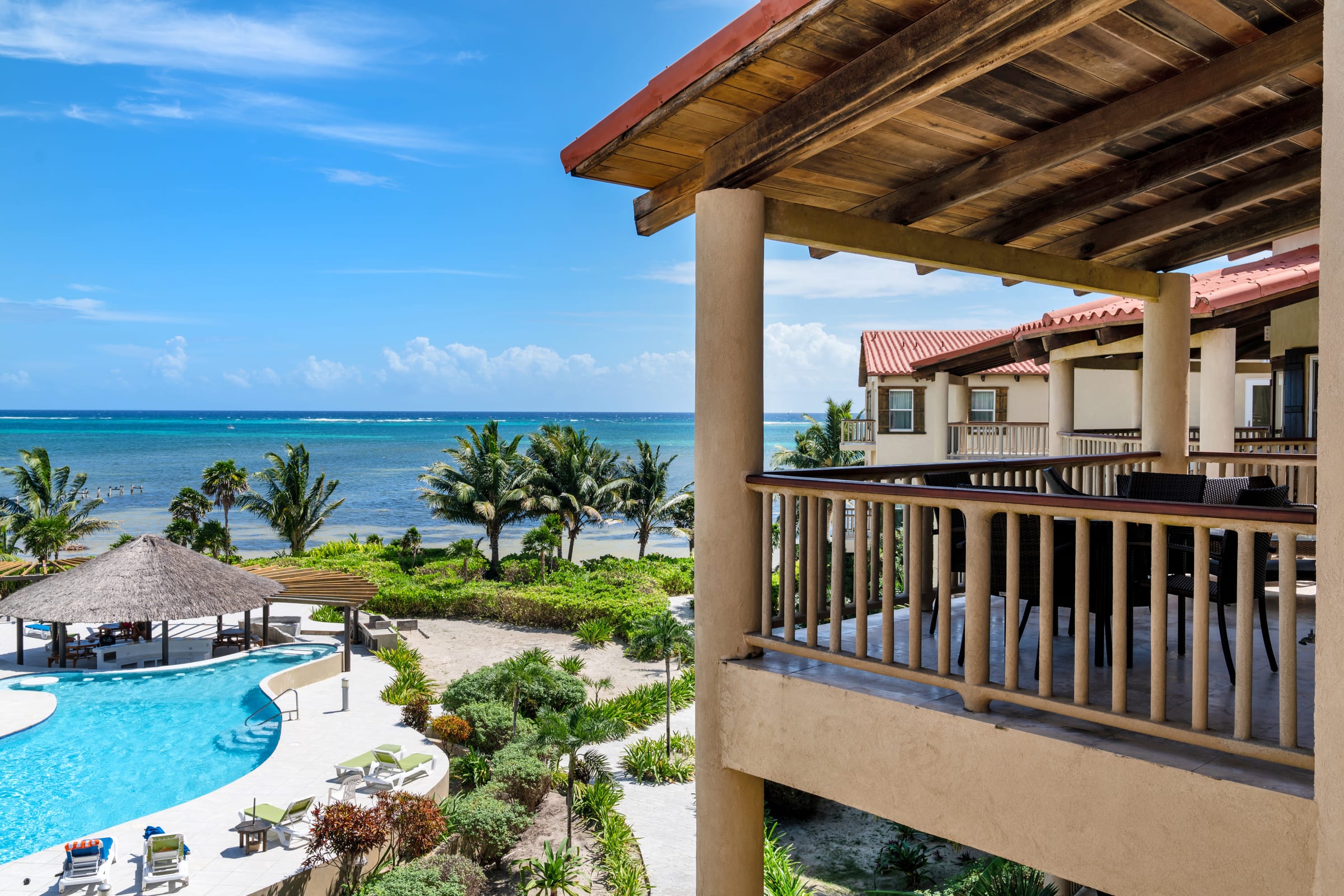 View from a covered balcony over the pools to the Caribbean Sea