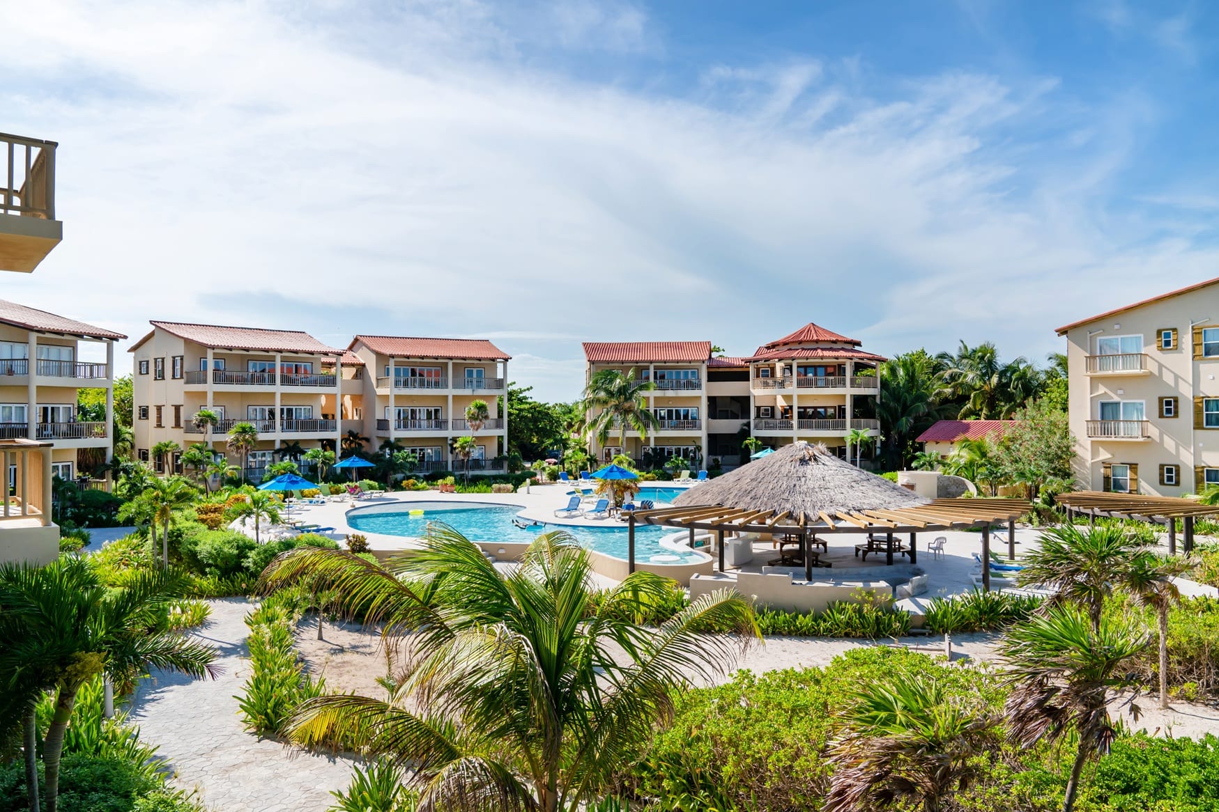 Resort pool with a thatched palapa bar