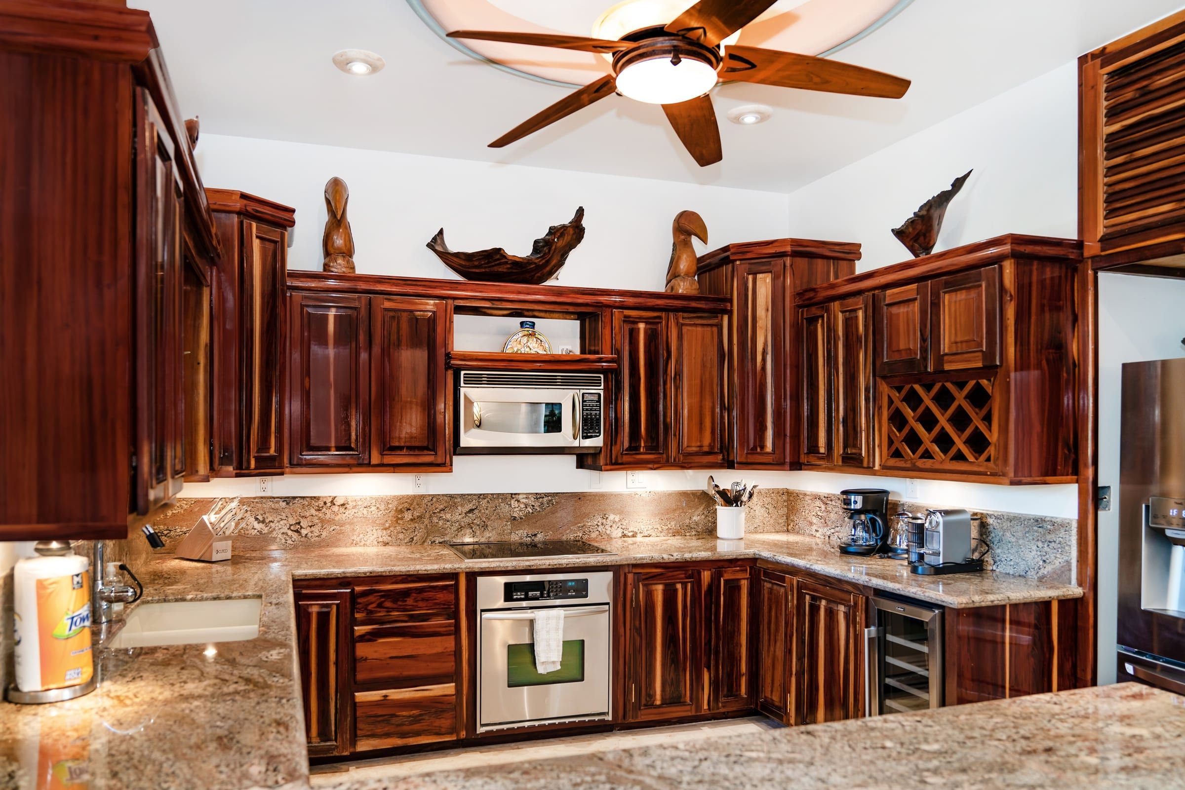 Kitchen with a cooktop, wall oven and wine rack