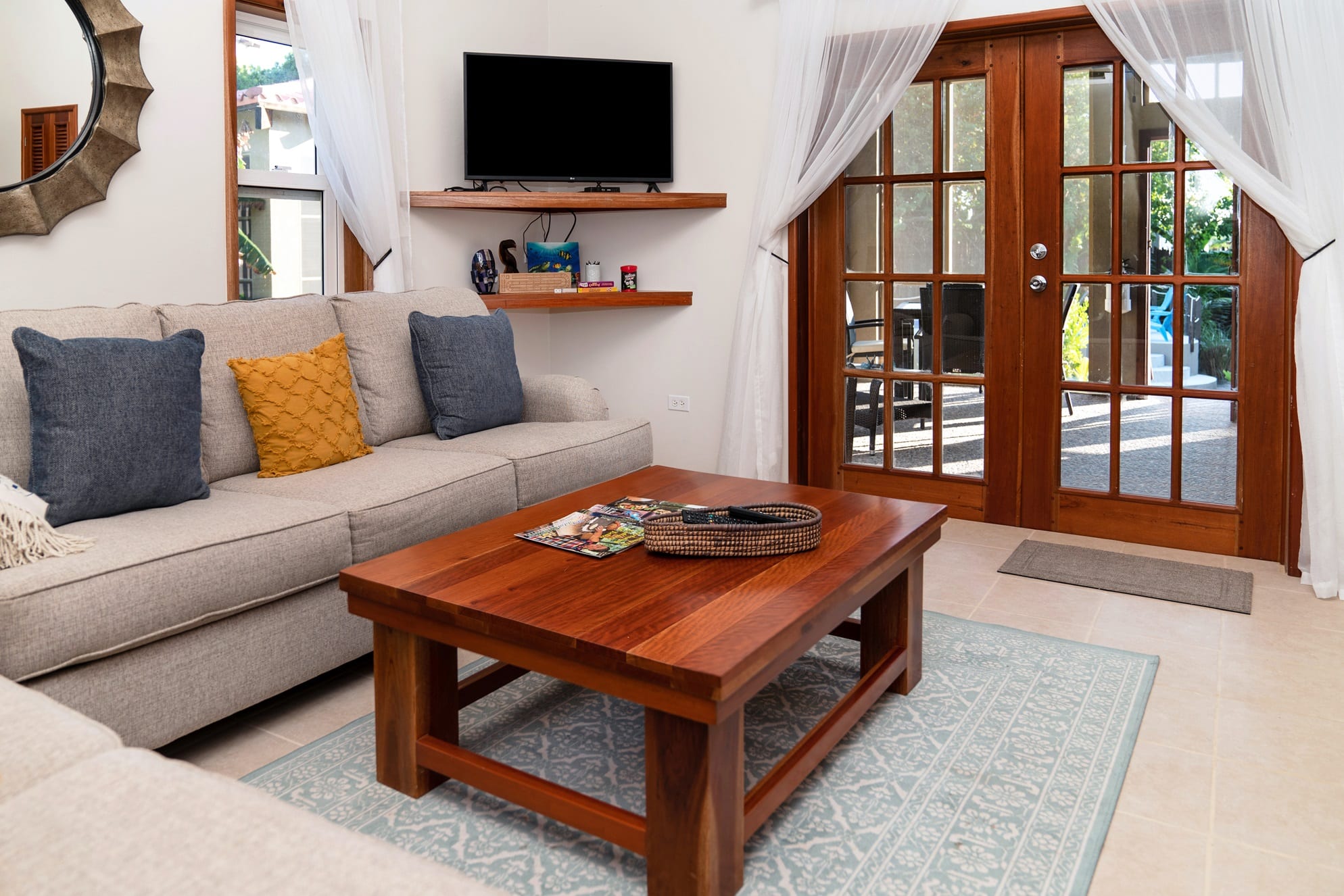 Living room with a sofa, a wood coffee table and glass doors