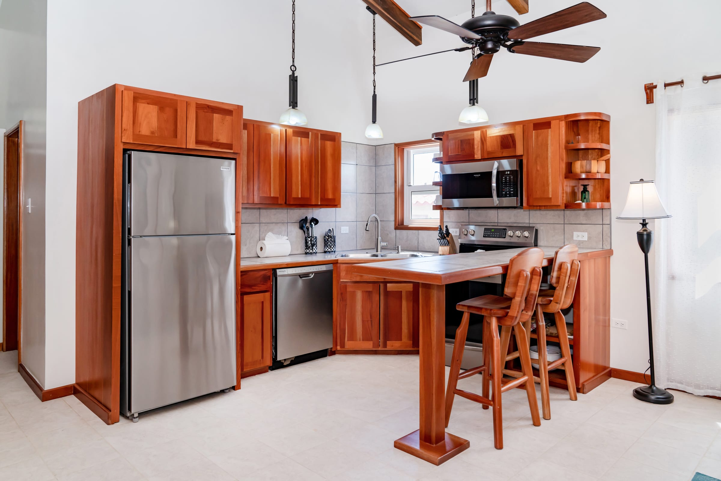 Kitchen with a stainless steel refrigerator and bar stools