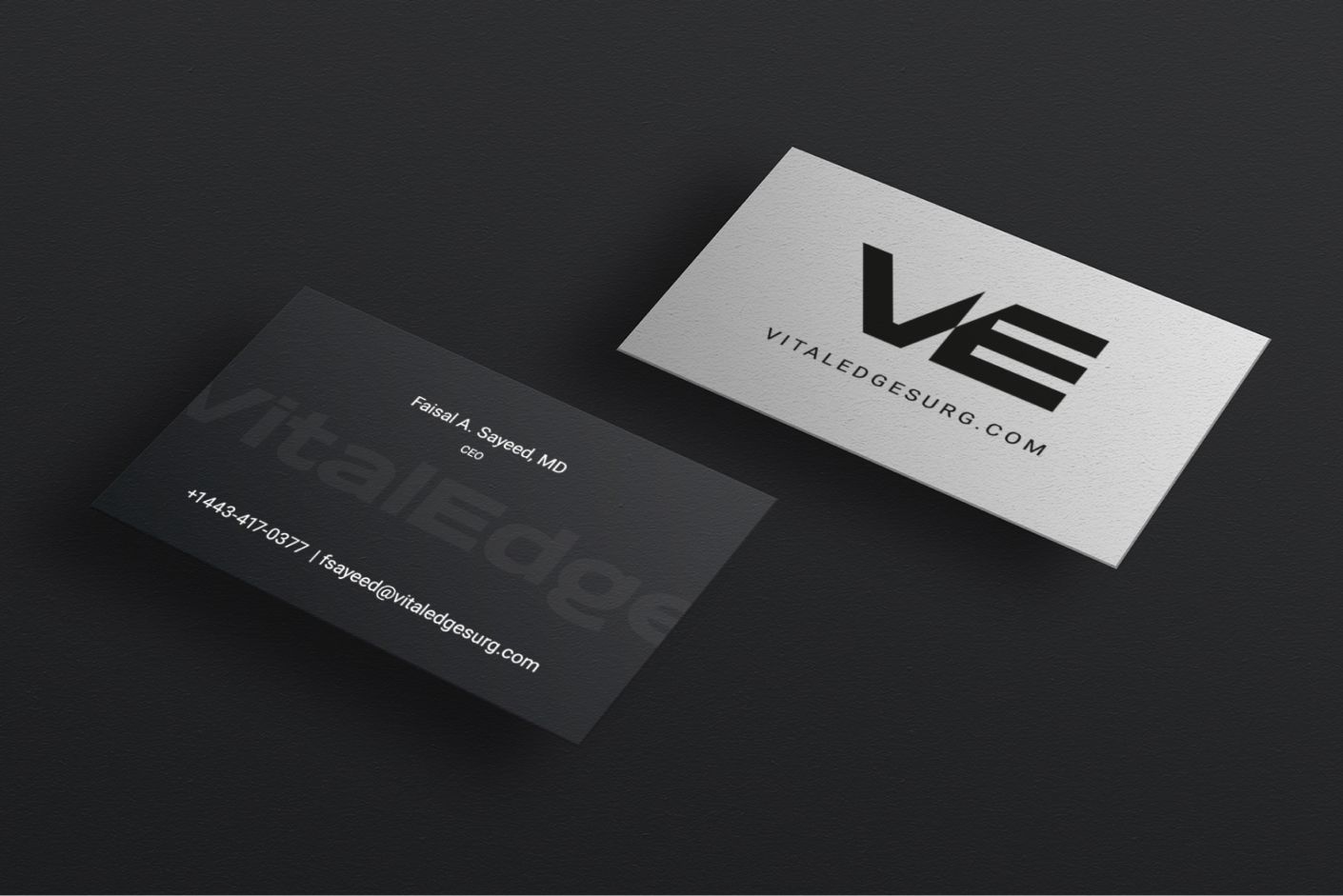 VitalEdge business cards with the VE monogram