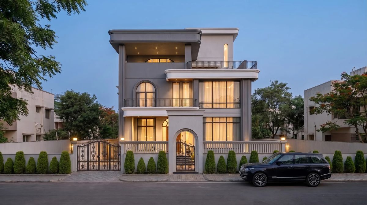 Three-storey villa with arched windows and a gated front, seen from the street — final render