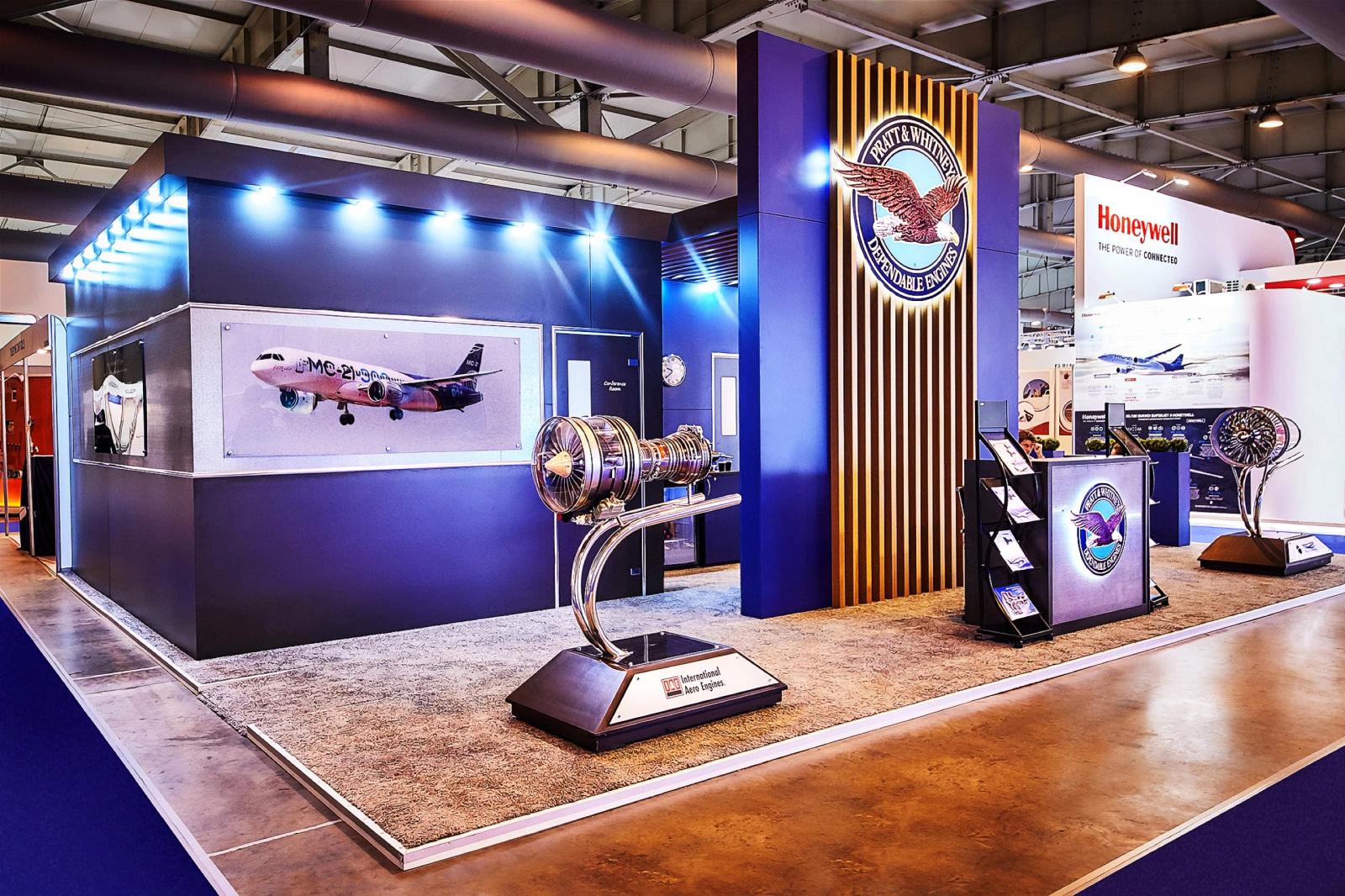 Custom Pratt and Whitney aerospace exhibition stand with a jet engine display on the show floor
