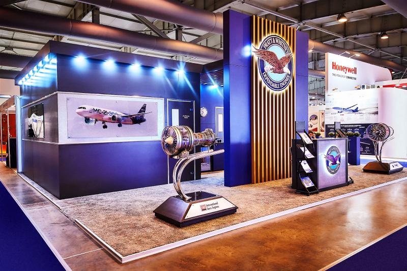 Custom Pratt and Whitney aerospace exhibition stand with a jet engine display on the show floor