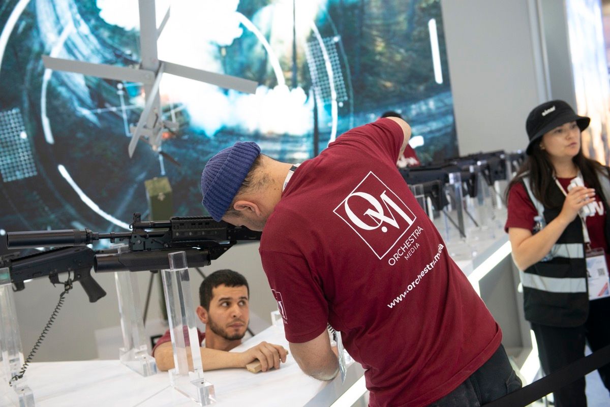 Orchestra Media crew in branded shirts installing product displays during exhibition build-up