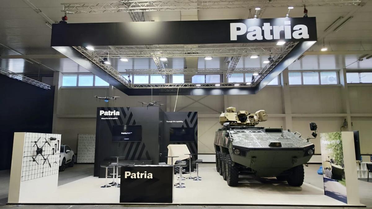 Patria defence stand with an armoured vehicle and unmanned systems on the exhibition floor