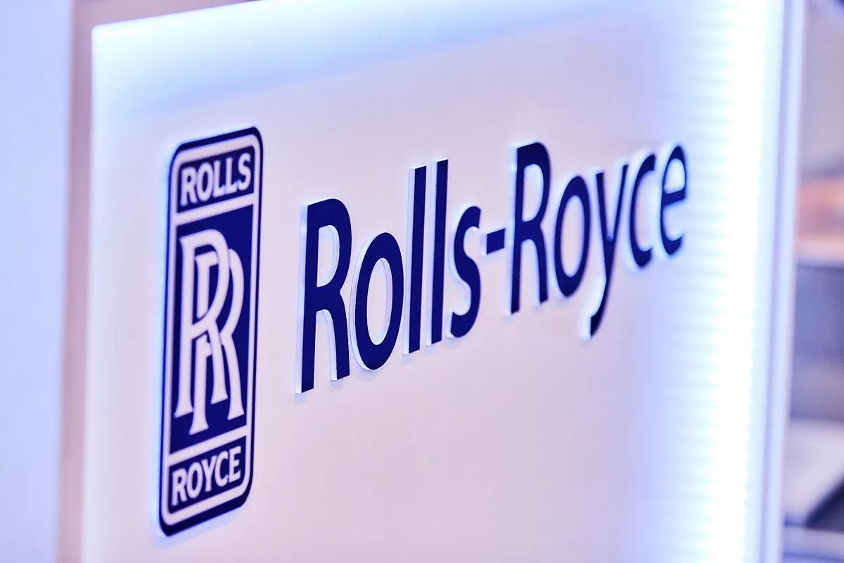 Illuminated Rolls-Royce logo wall on an exhibition stand.