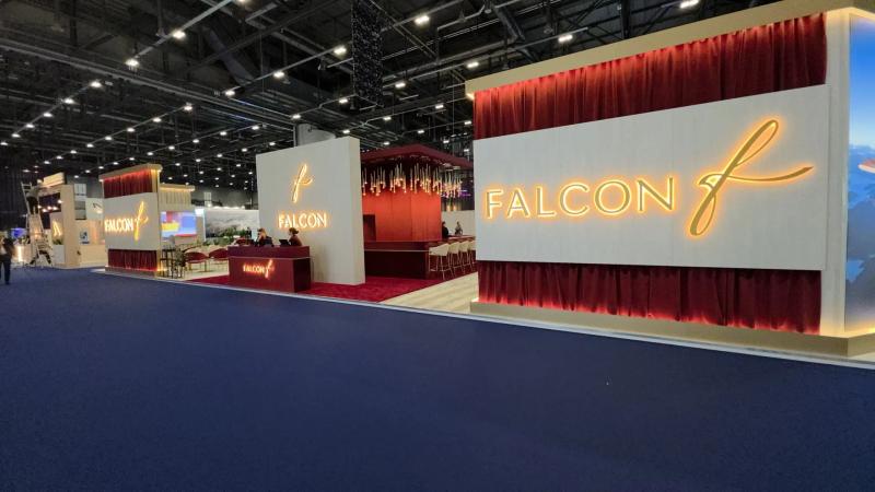 Large custom aviation exhibition stand with illuminated branding and hospitality area built by Orchestra Media