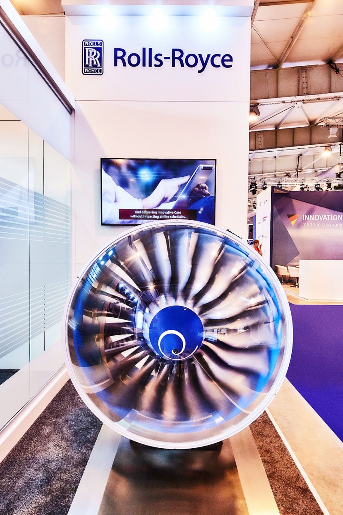 A Rolls-Royce aero engine fan displayed on a custom exhibition stand