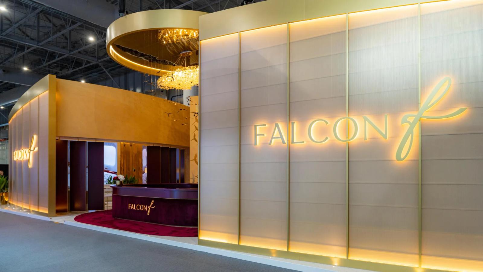 Premium custom exhibition stand with backlit logos and VIP lounge built by Orchestra Media at a Dubai show