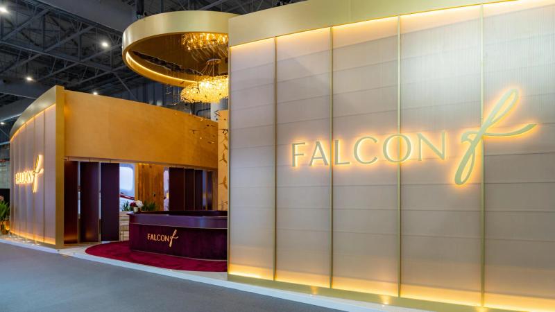 Premium custom exhibition stand with backlit logos and VIP lounge built by Orchestra Media at a Dubai show