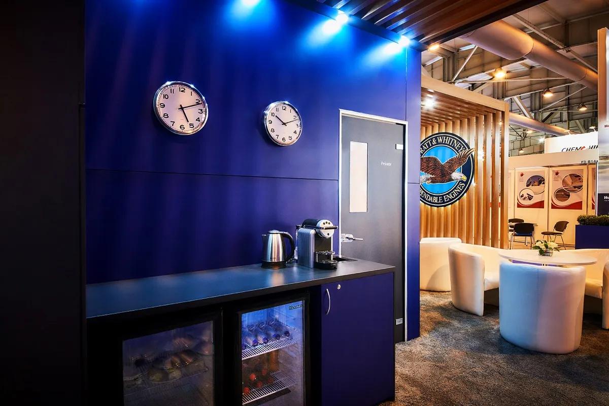 A private meeting area and hospitality space built into a custom aviation exhibition stand
