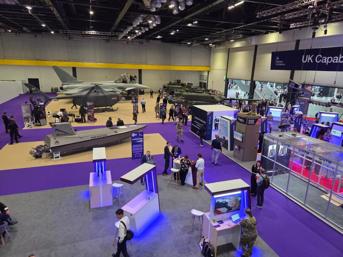 Defence industry exhibition stand displaying military systems and equipment at a tri-service defence expo