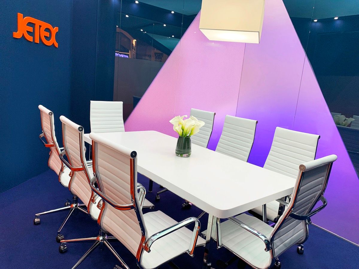 Private meeting room built into a Jetex aviation exhibition stand with branded wall and boardroom seating