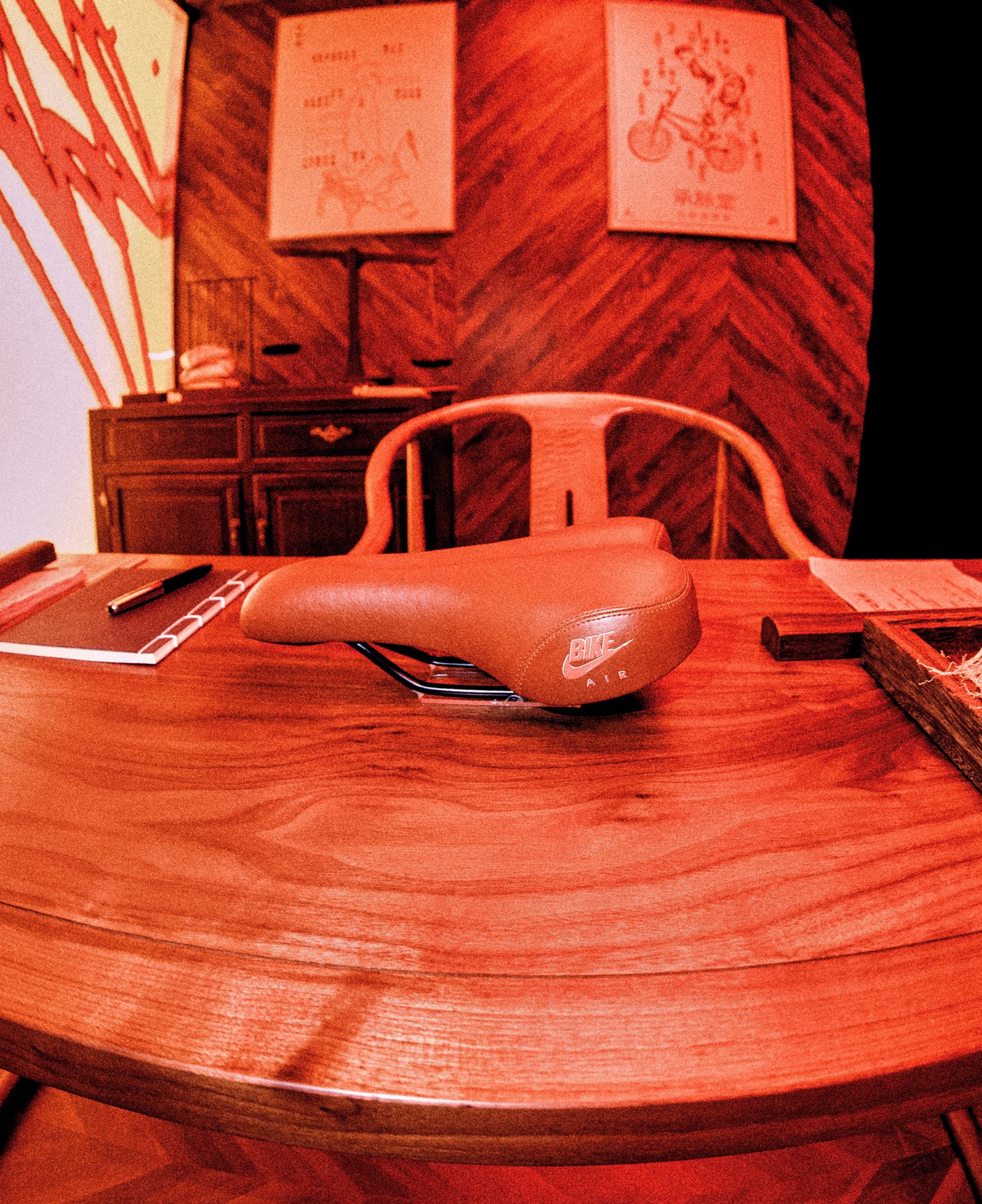 BMX saddle resting on a wooden consultation table inside Cheng Mai Tang