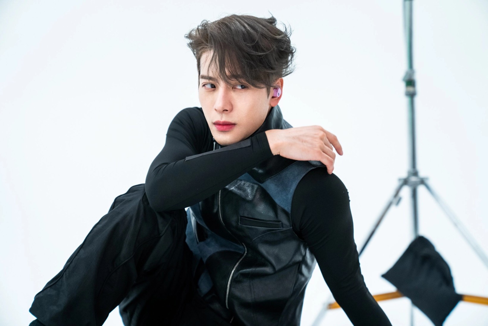 Jackson Wang posing on a white studio set during the shoot