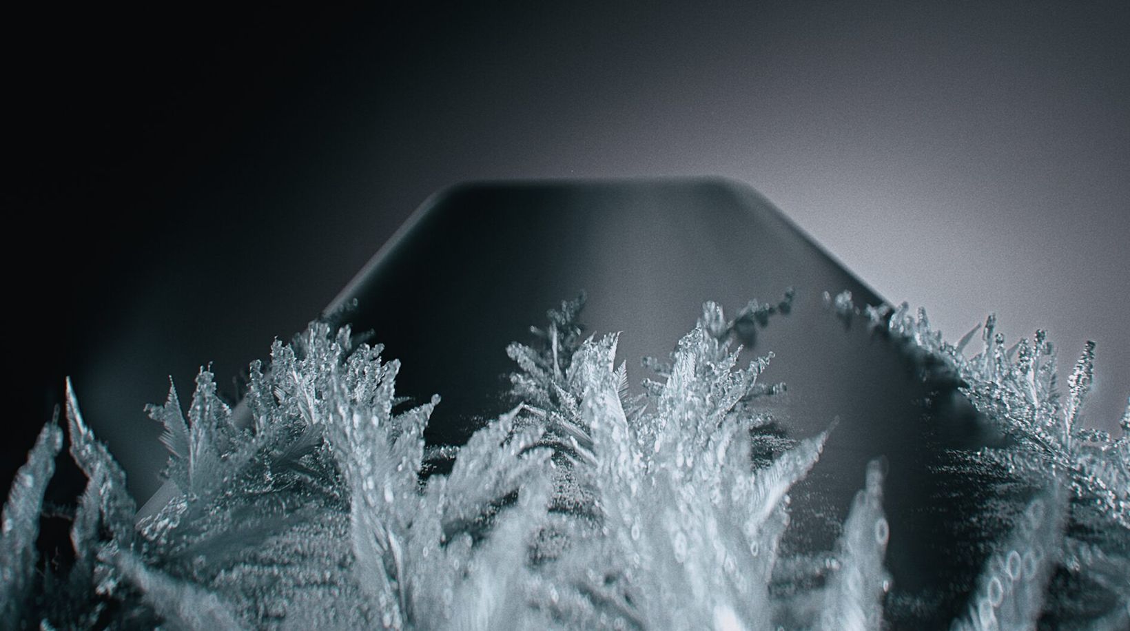 Frost crystals growing over the edge of a phone