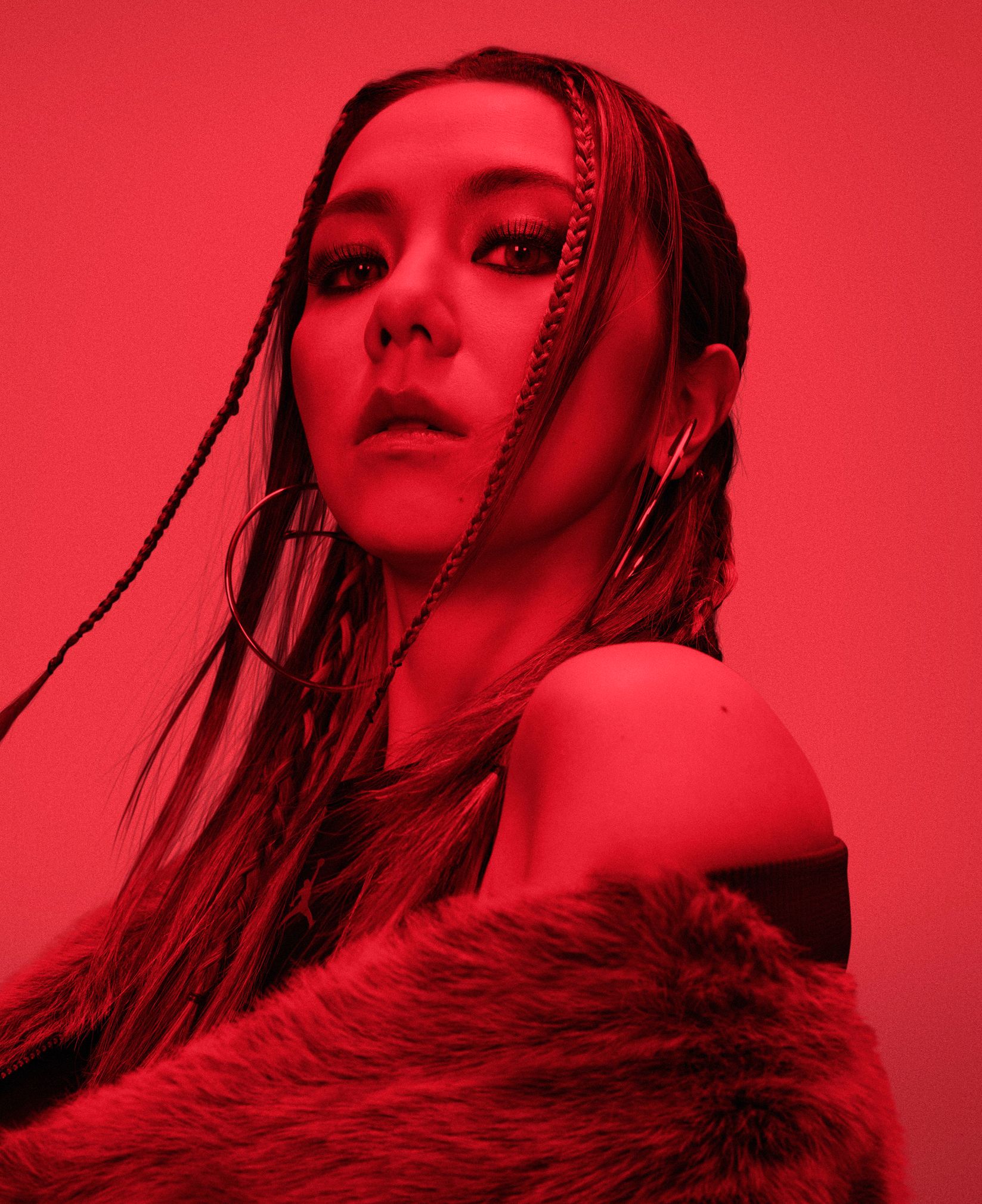G.E.M. in a fur coat against a red background