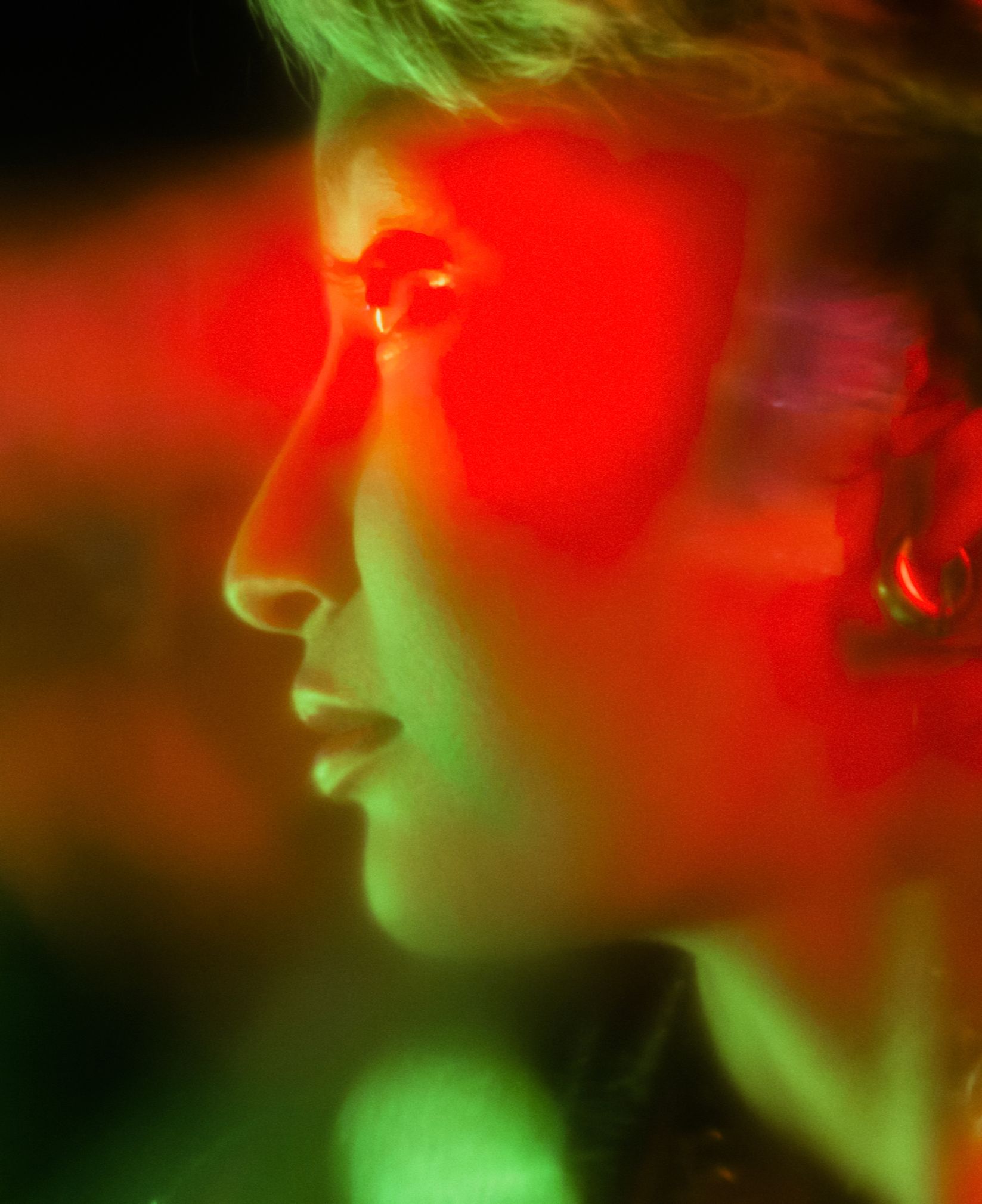 Woman laughing as she reaches toward a glowing light