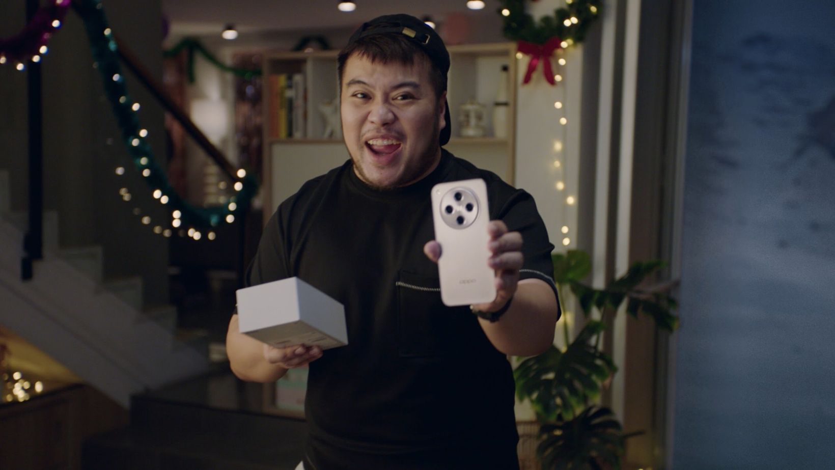 Film still of a livestream host holding up an OPPO phone