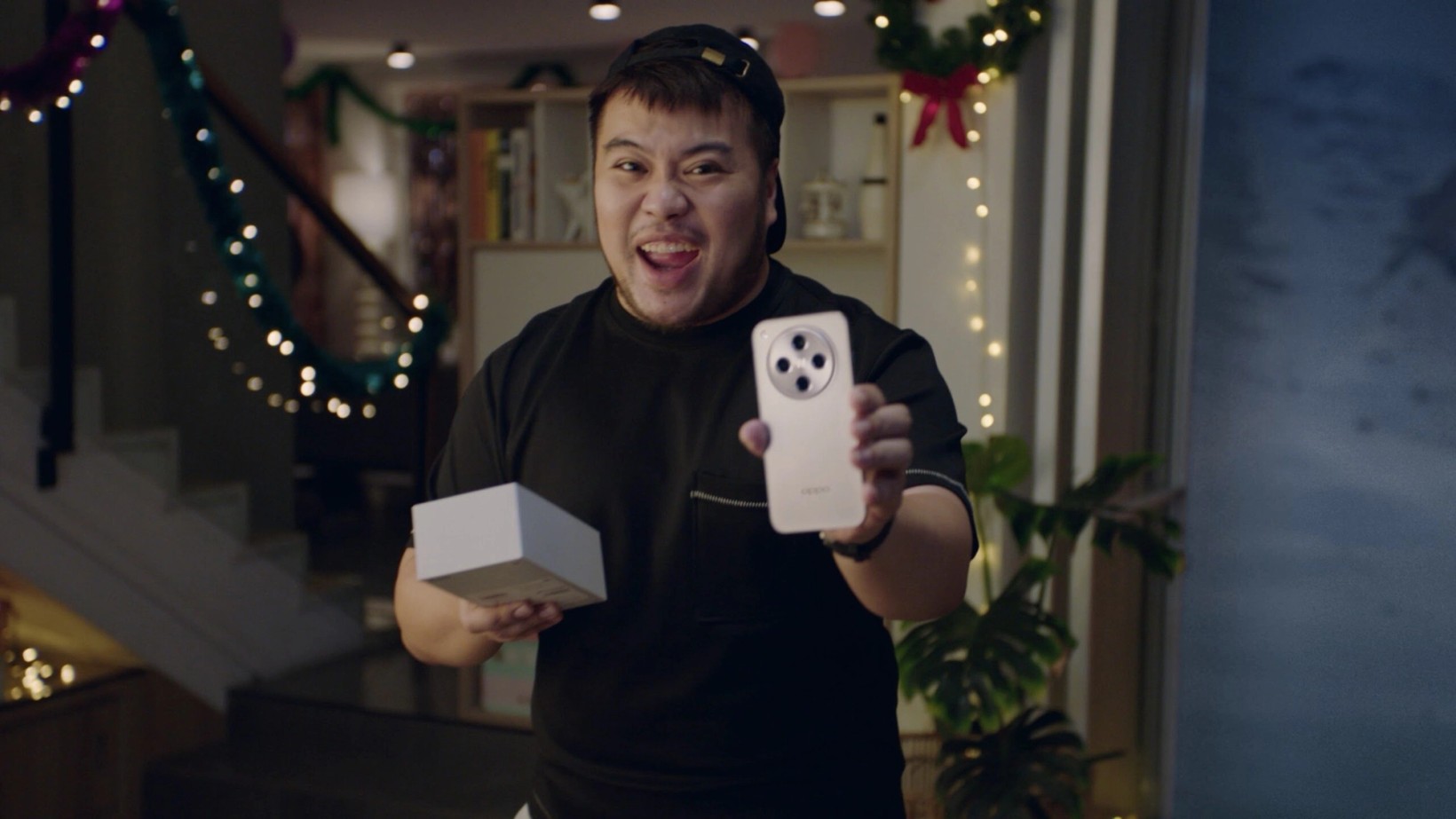 Film still of a livestream host holding up an OPPO phone