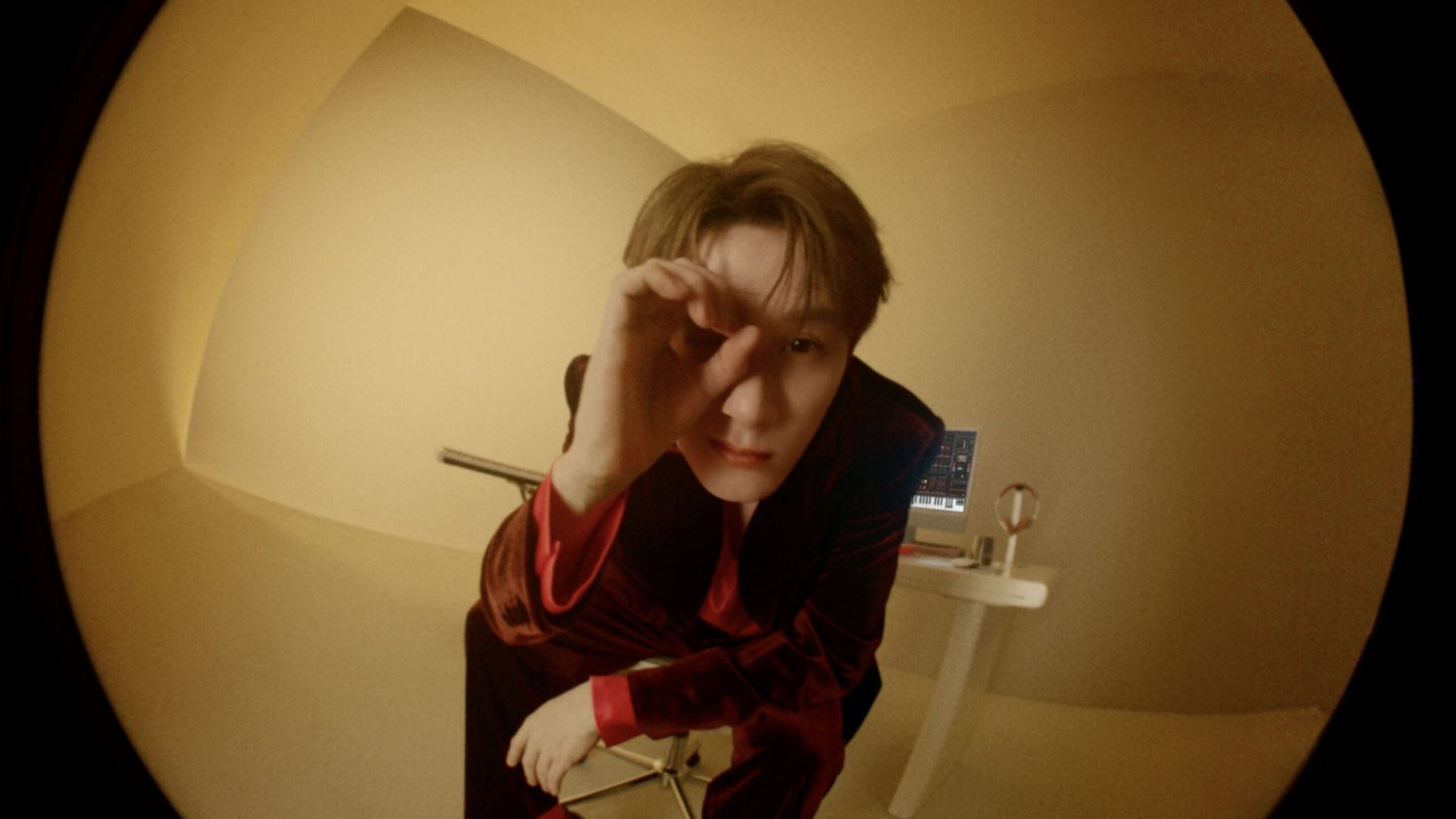Film still of Tan Jianci through a fisheye lens