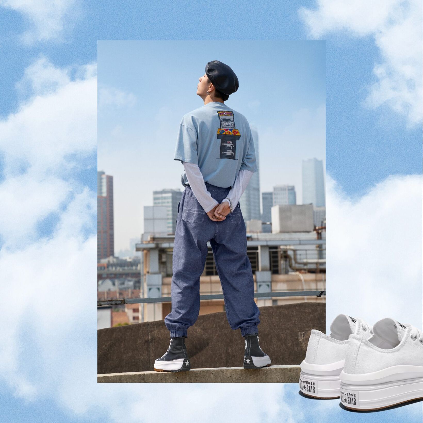 Lookbook image of a man from behind on a rooftop with white Converse platform sneakers