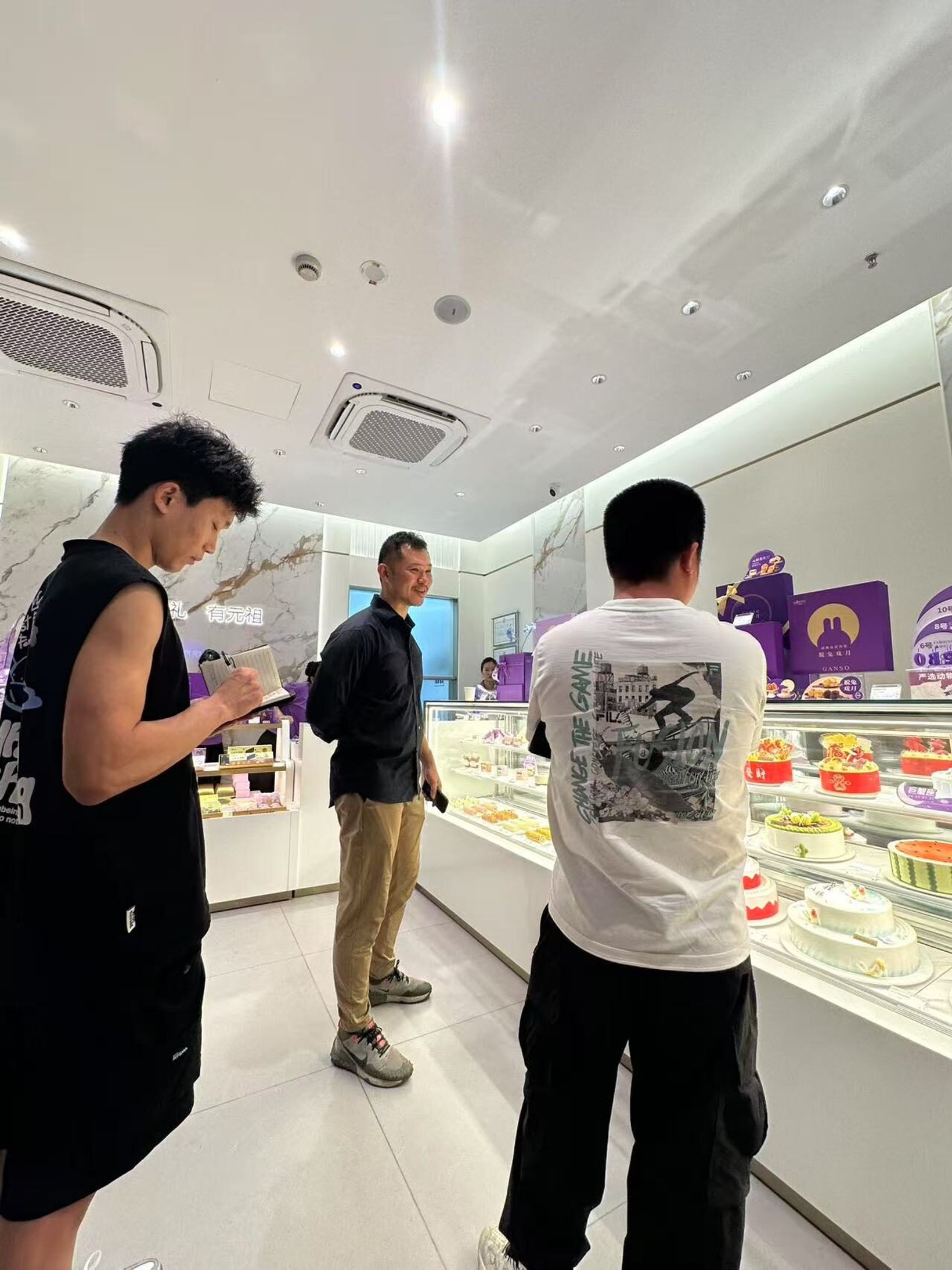 Researchers observing customers at a GANSO cake counter