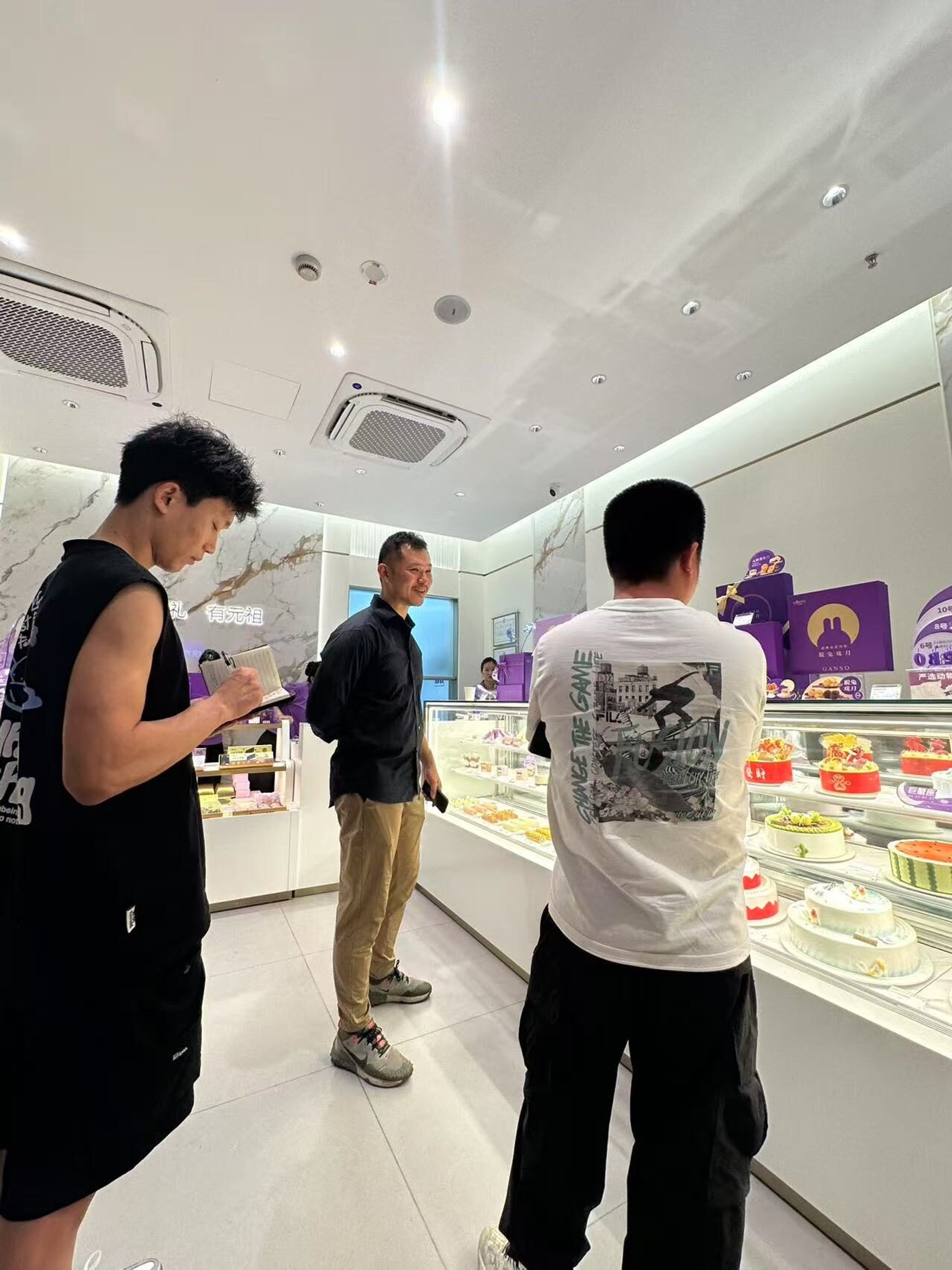 Researchers observing customers at a GANSO cake counter
