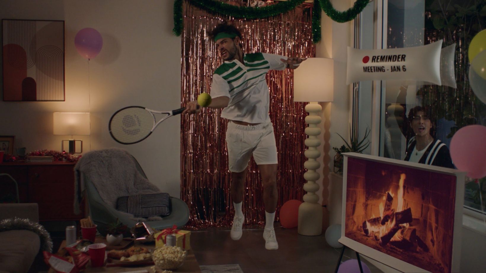 Film still of a tennis player in a living room decorated for the holidays