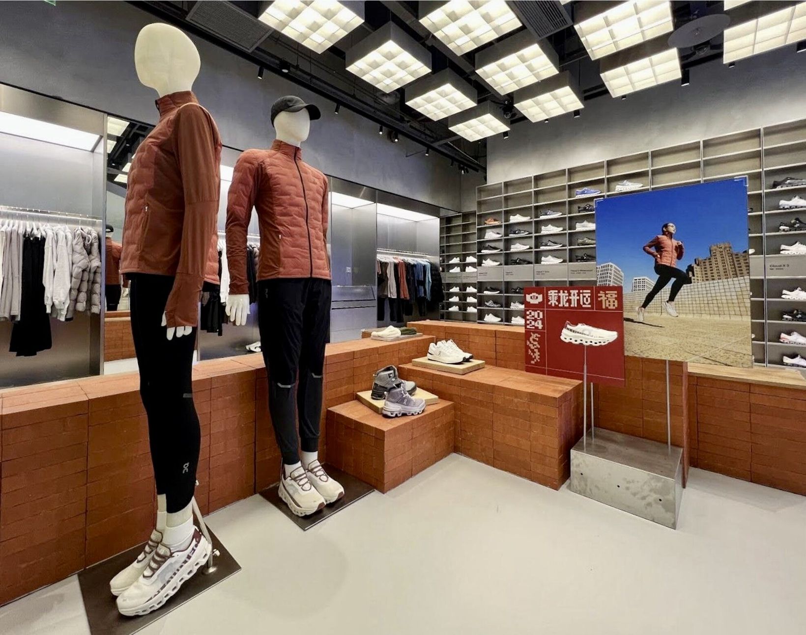 On store interior with mannequins in red jackets and a campaign display