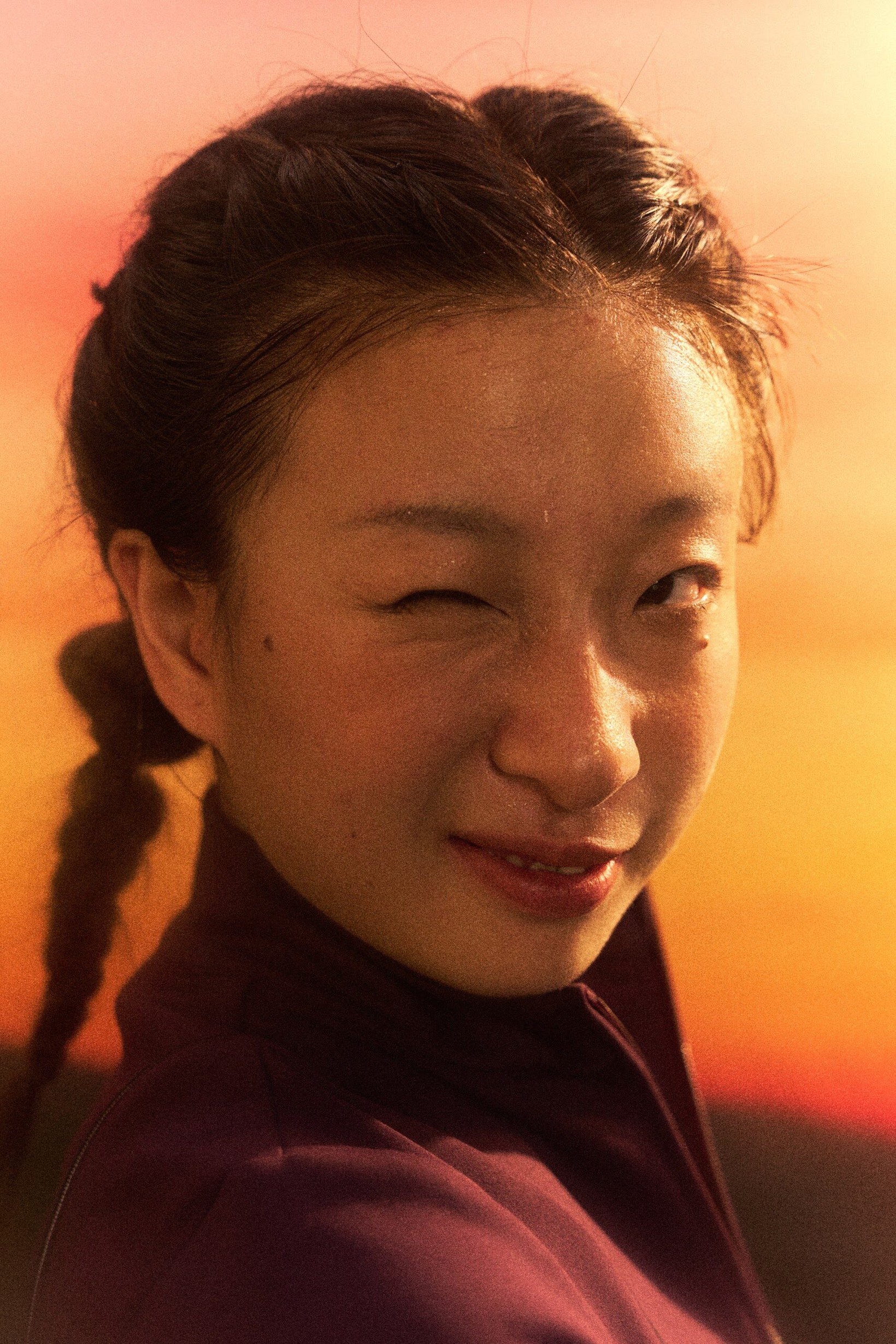 Close-up portrait of a smiling woman glowing in warm sunset light