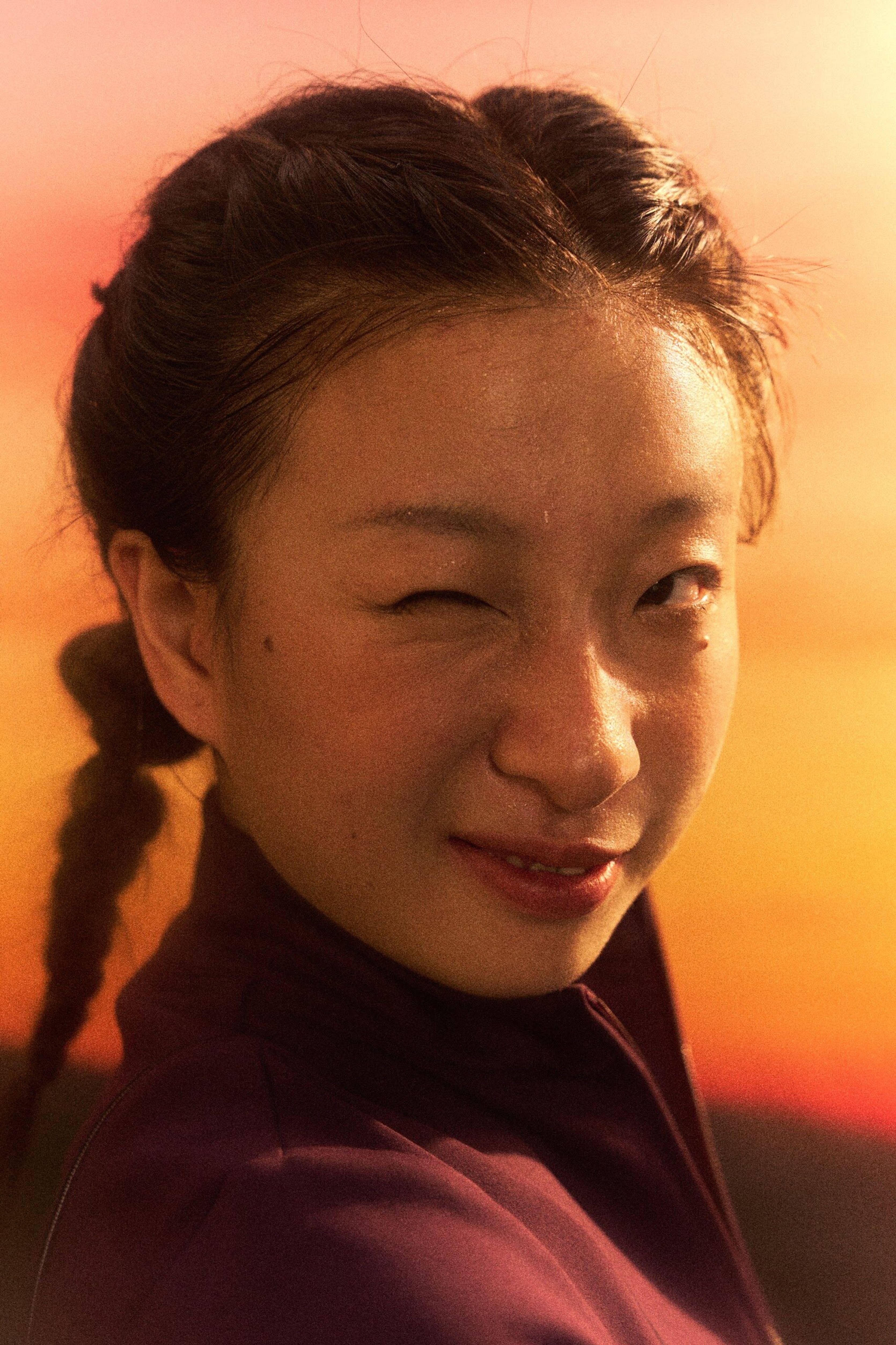 Close-up portrait of a smiling woman glowing in warm sunset light