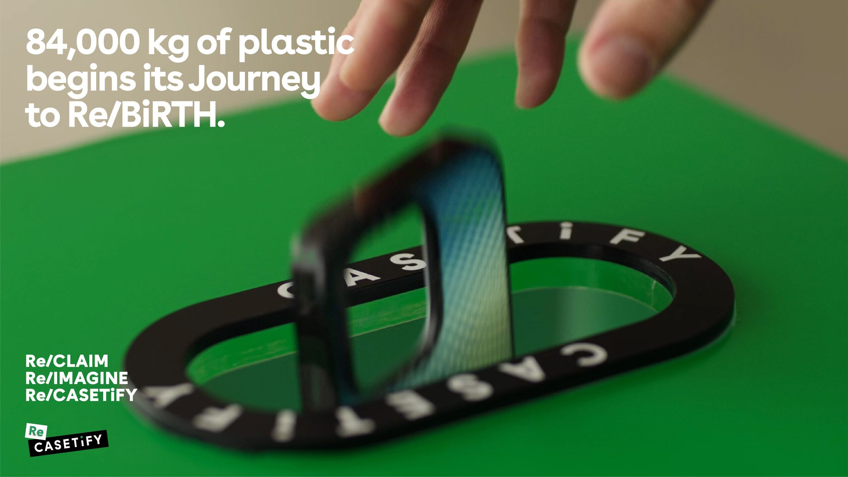 Journey to Rebirth key visual of a hand dropping a phone case into a CASETiFY recycling slot