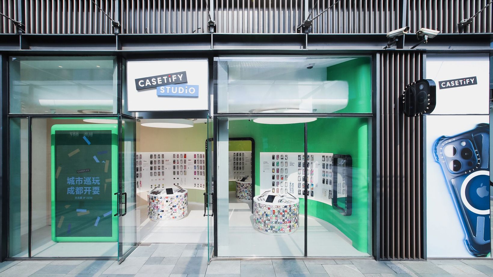 CASETiFY Studio storefront with green-lit interior and a phone display in the window