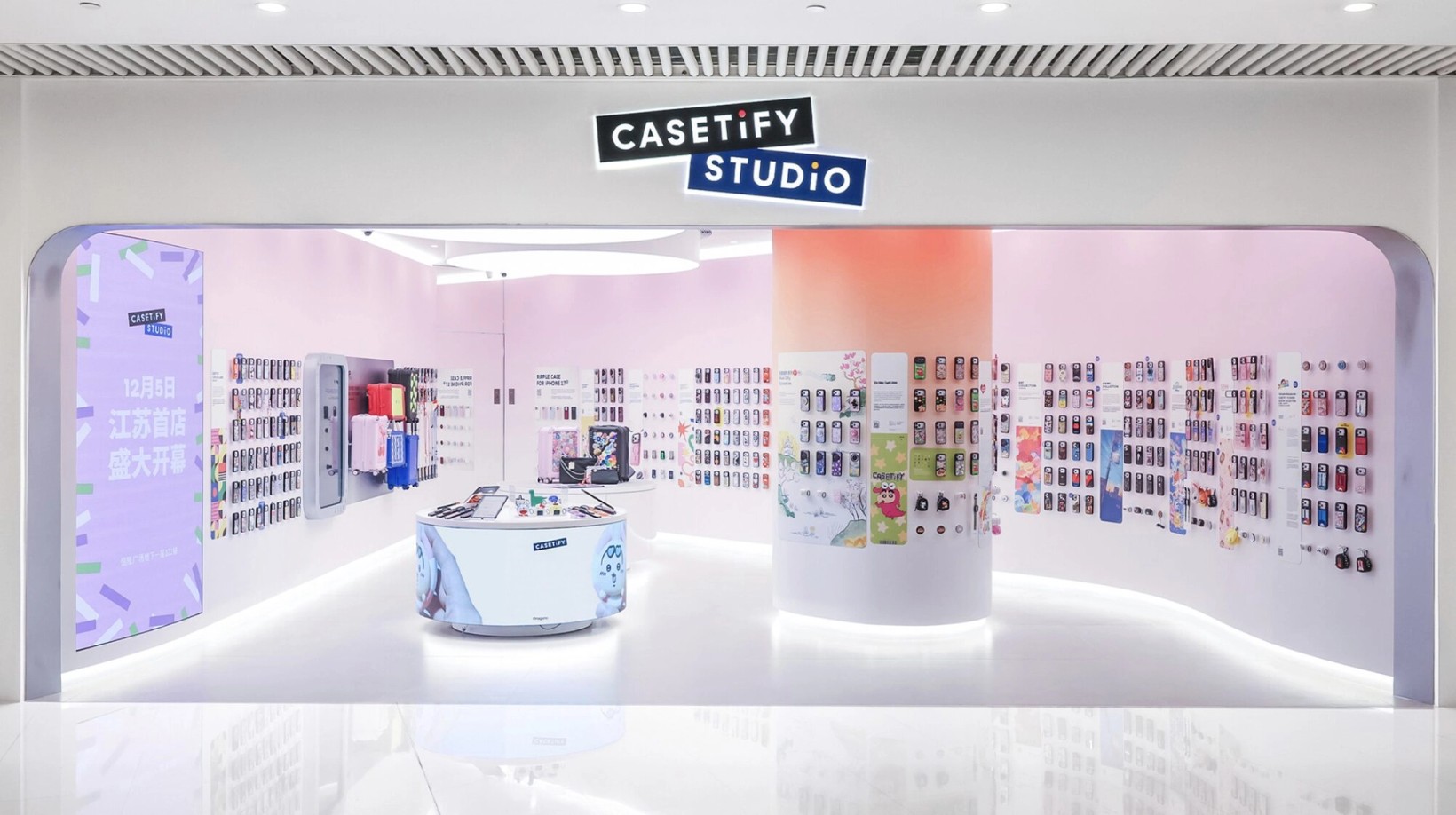 CASETiFY Studio store with pastel walls of phone cases around a central counter