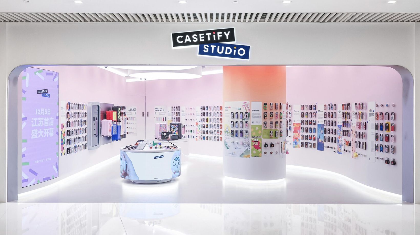 CASETiFY Studio store with pastel walls of phone cases around a central counter
