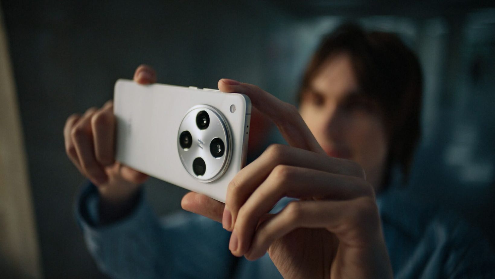Film still of a man taking a photo with an OPPO Find X8