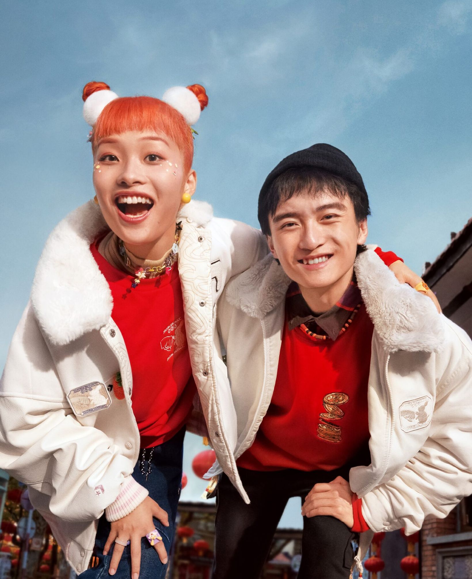 Two friends in red and white Converse outfits grinning at the camera
