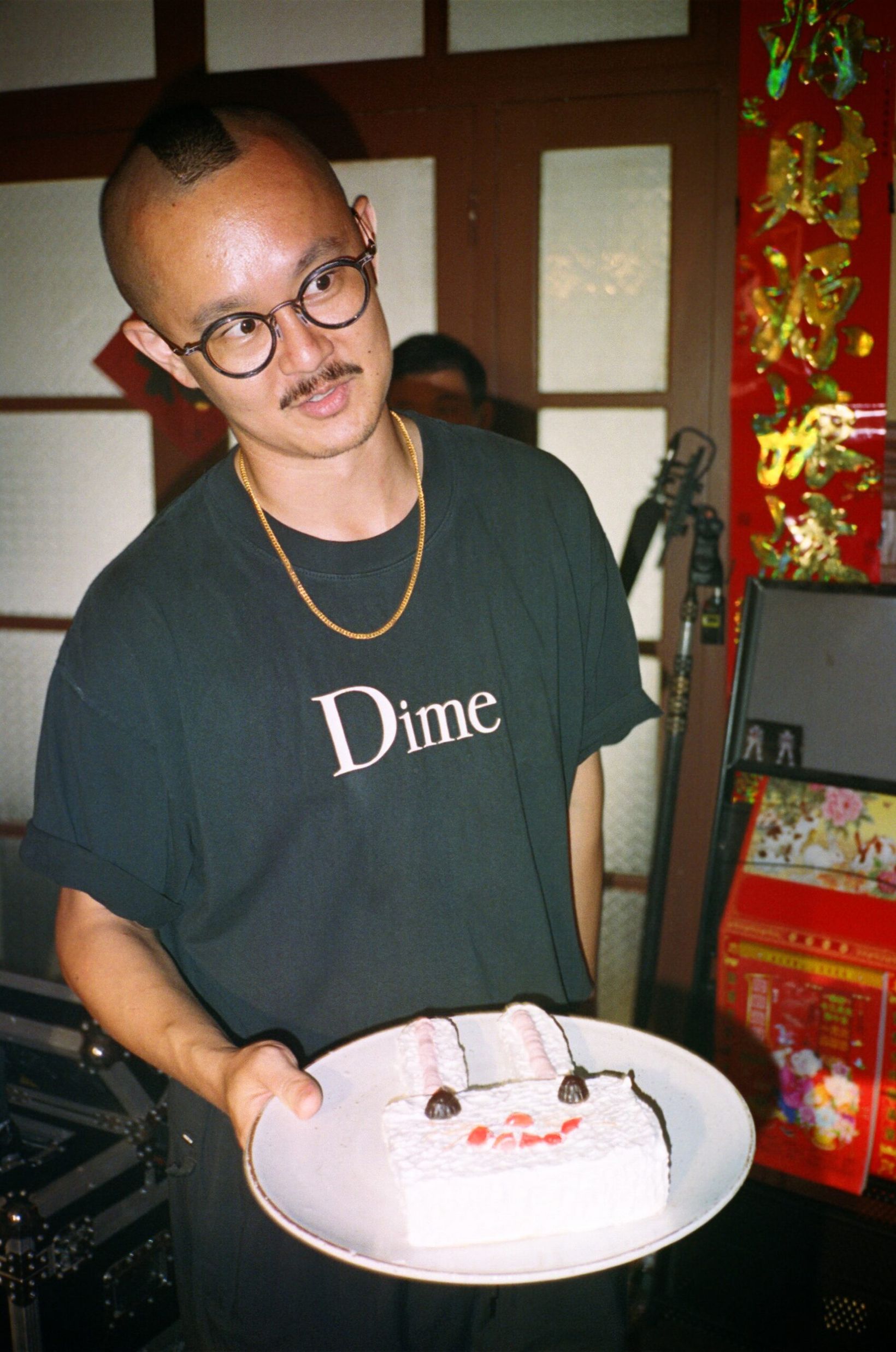 Behind the scenes: creative in a Dime T-shirt holding a bunny cake